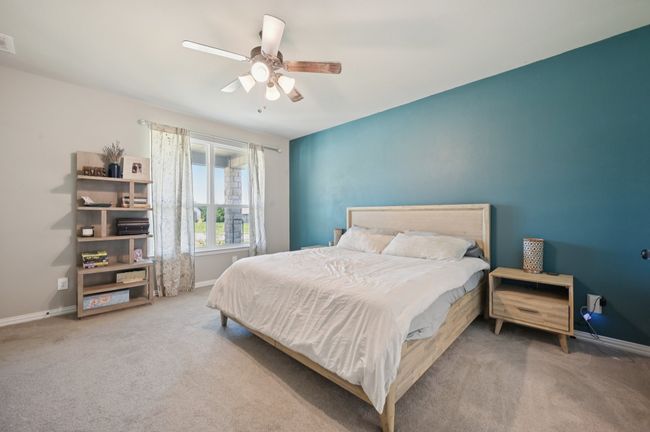 Primary bedroom with carpet flooring and a ceiling fan | Image 10