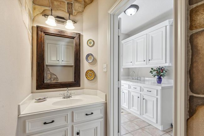 The second powder bath on the first level of the home is conveniently located near the hard working mud room and kitchen. | Image 25