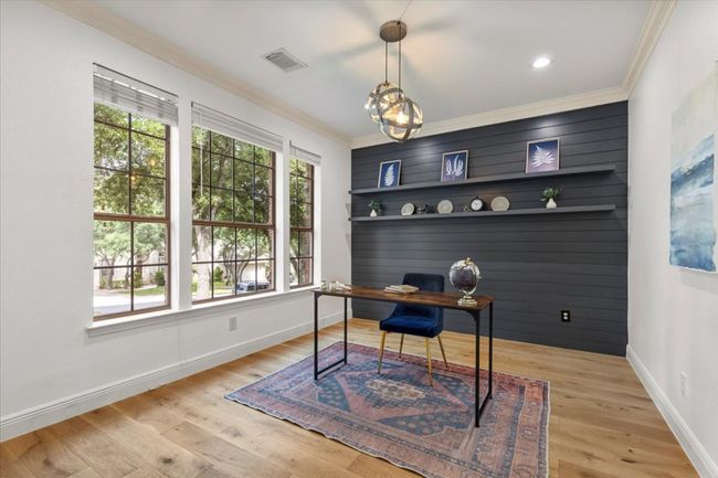 Home office with glass french doors, custom shiplap shelf wall and front yard views | Image 5