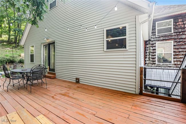 Wooden deck featuring outdoor dining area | Image 45