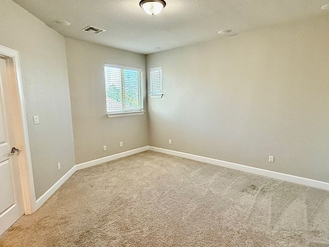 Unfurnished room with light colored carpet and baseboards | Image 27