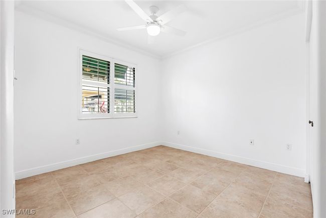 Unfurnished room featuring crown molding, light tile patterned flooring, and ceiling fan | Image 27