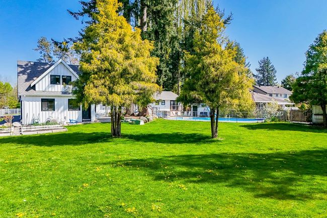 View of yard with fence and a fenced in pool | Image 30