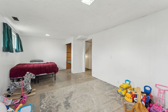 Bedroom with concrete flooring and visible vents | Image 22