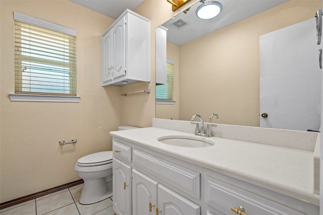 Bathroom with vanity, plenty of natural light, and tile patterned floors | Image 31