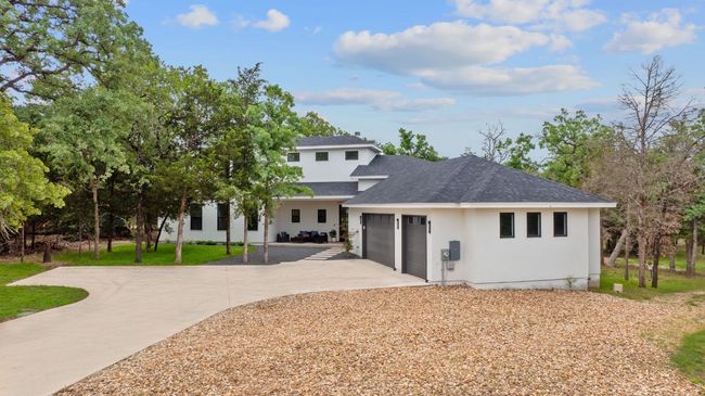 Front of property with roof with shingles, an attached garage, stucco siding, concrete driveway, and a lawn | Image 36