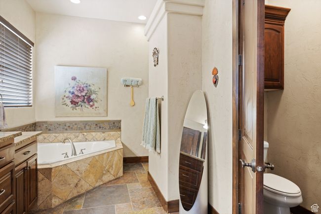 Full bathroom featuring stone tile flooring, a bath, vanity, and recessed lighting | Image 25