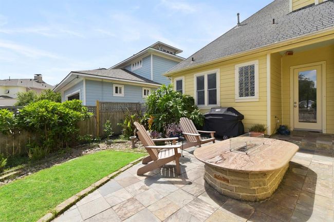 Enjoy the tranquil sounds of the fountain while relaxing by the cozy fireplace. | Image 41