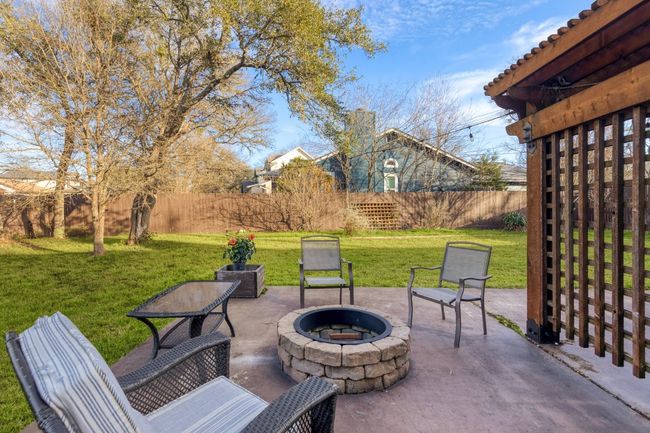 The fire pit on the back patio creates a warm, inviting gathering spot perfect for chilly evenings, where you can roast marshmallows, tell stories, or simply enjoy the flames dancing under the stars | Image 26