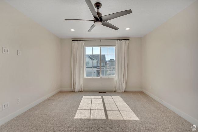 Carpeted empty room with ceiling fan and recessed lighting | Image 15
