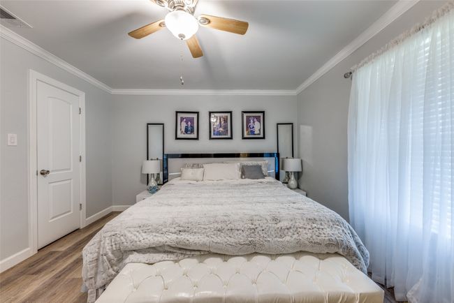 Bedroom featuring crown molding, light wood-style flooring, and a ceiling fan | Image 15
