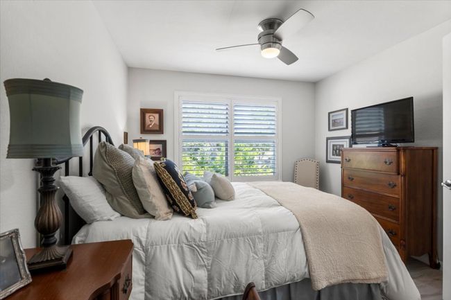 Bedroom featuring a ceiling fan and wood finished floors | Image 7