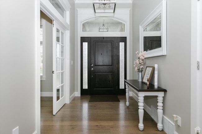 Entrance foyer featuring baseboards and wood finished floors | Image 26