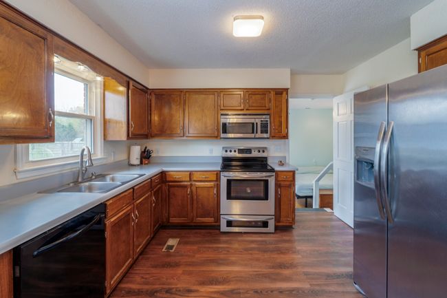 Kitchen with view to the huge back-yard leading down to Primary Suite | Image 9