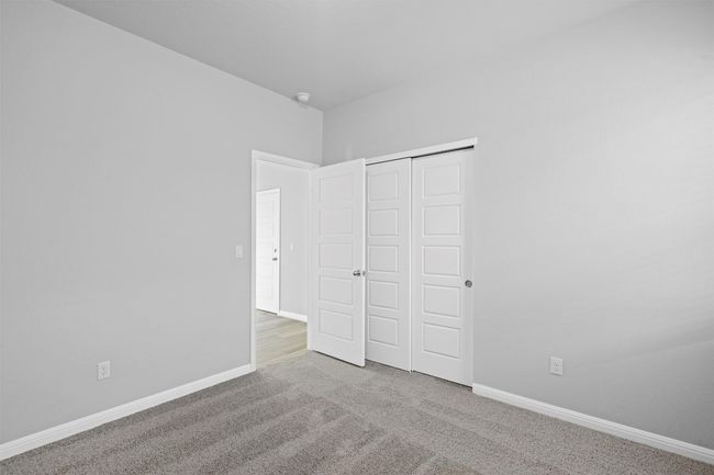 Unfurnished bedroom featuring carpet flooring and a closet | Image 18
