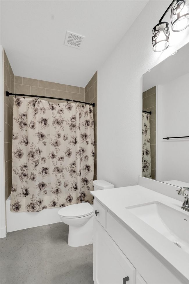 Laundry area featuring washing machine and clothes dryer and baseboards | Image 28