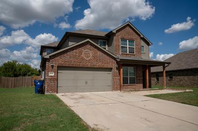 View of front of house featuring a garage and a front yard | Image 3