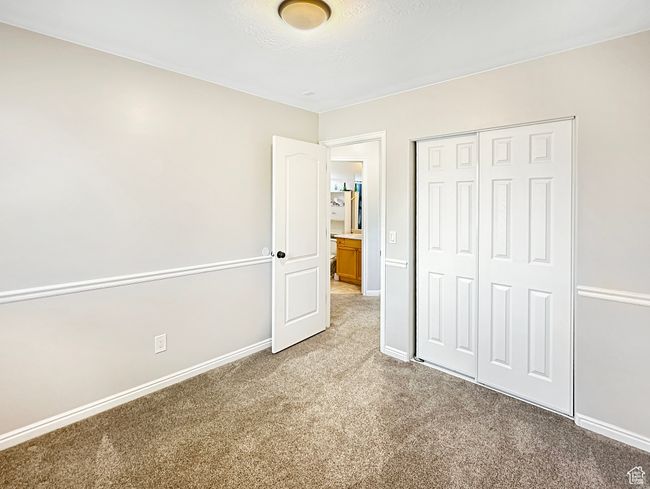 Unfurnished bedroom featuring a closet and carpet floors | Image 12