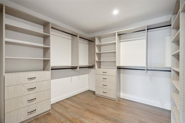 Spacious closet with light wood-style floors | Image 18