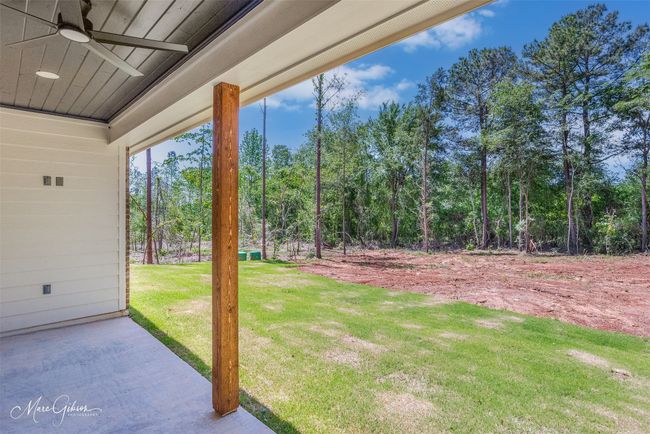 View of yard featuring a ceiling fan and a patio | Image 23