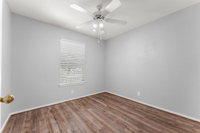 Guest Bedroom 1 featuring wood finished floors and a ceiling fan | Image 18