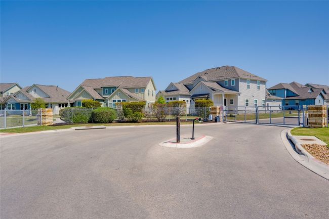 View of street with a residential view, a gate, and curbs | Image 27