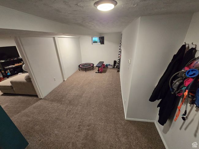 Interior space with carpet and a textured ceiling | Image 30