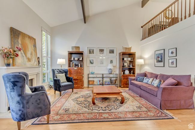 Living room featuring wood finished floors, beam ceiling, and high vaulted ceiling | Image 8