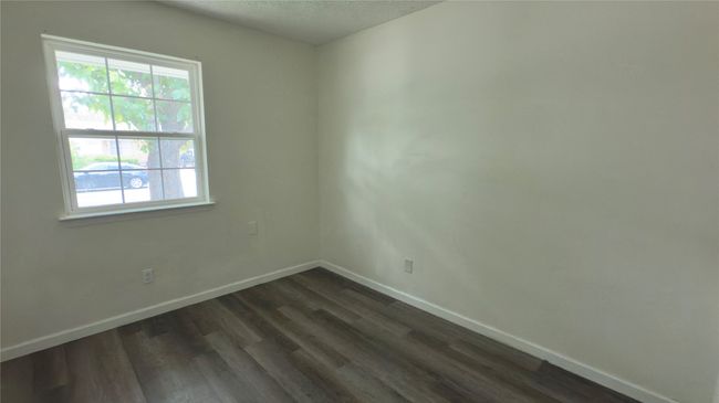 Unfurnished room featuring dark wood-type flooring and a textured ceiling | Image 34