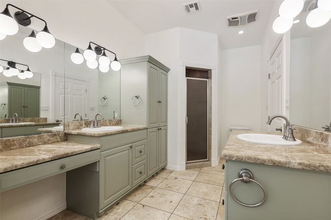 Bathroom with a shower stall, two vanities, and tile patterned floors | Image 7