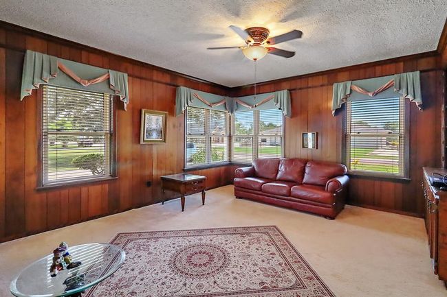The den has built ins and a panoramic view of the front yard. | Image 9
