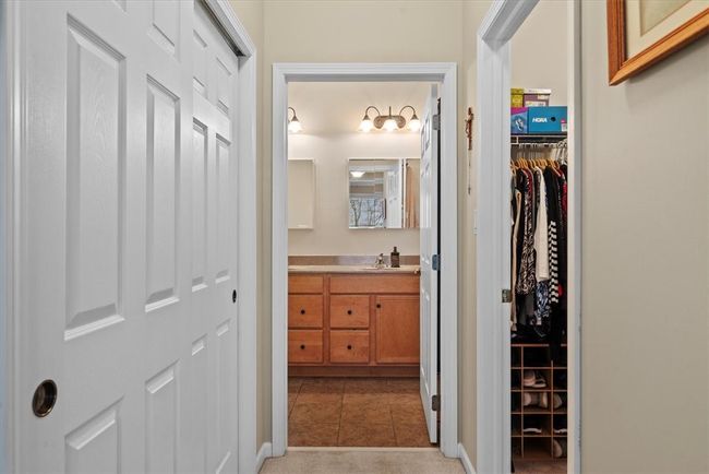 A hallway leads to the master bathroom with a large sliding closet to the left and 7x5 walk in closet on the right. | Image 17