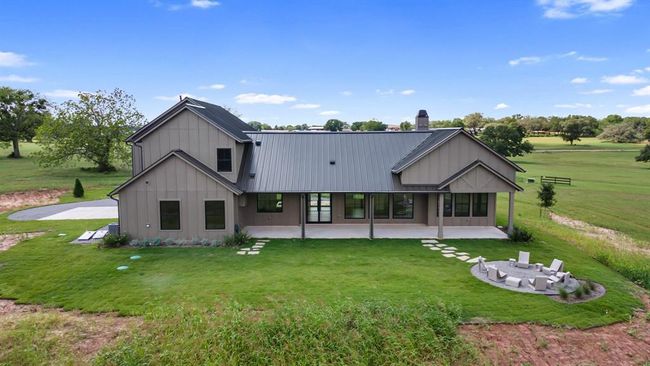 A rear view shows the covered back patio and the perfect location for a pool! | Image 45