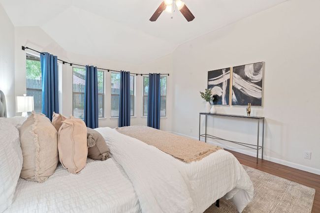 The secluded main floor primary suite serves as your peaceful getaway for rest & relaxation. | Image 19