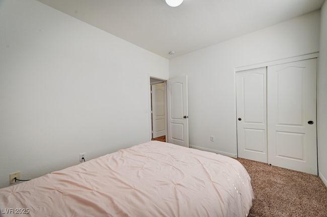 Carpeted bedroom with a closet and baseboards | Image 18