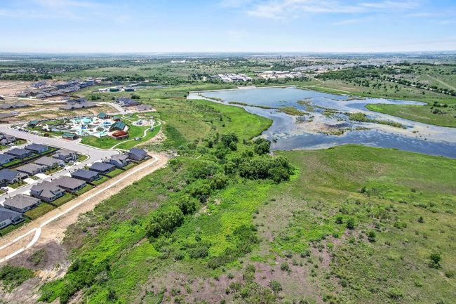 View of property location with a large body of water and nearby suburban area | Image 38