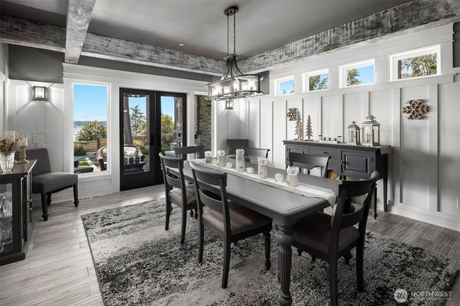 Dining area with doors that open to outdoor covered living space. | Image 9