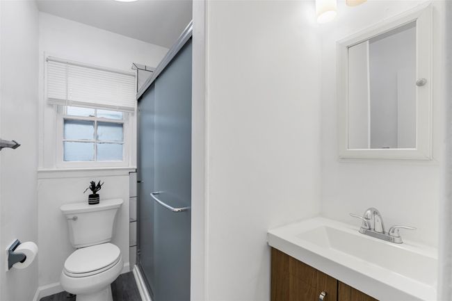 Bathroom with vanity, toilet, and a shower stall | Image 12
