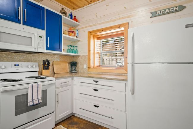 Kitchen with open shelving, cabinet space and a pocket window! | Image 10