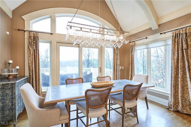 Dinette with hickory floors, arched beam ceilings , and glass siding doors that lead to trex deck and magnificent backyard | Image 11
