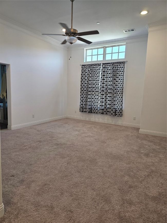 Carpeted empty room featuring ornamental molding, a ceiling fan, and recessed lighting | Image 11