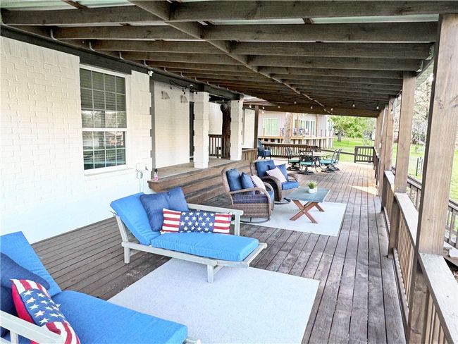 Deck with an outdoor hangout area | Image 26