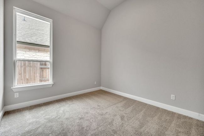 Spare room featuring carpet floors, vaulted ceiling, and baseboards | Image 24