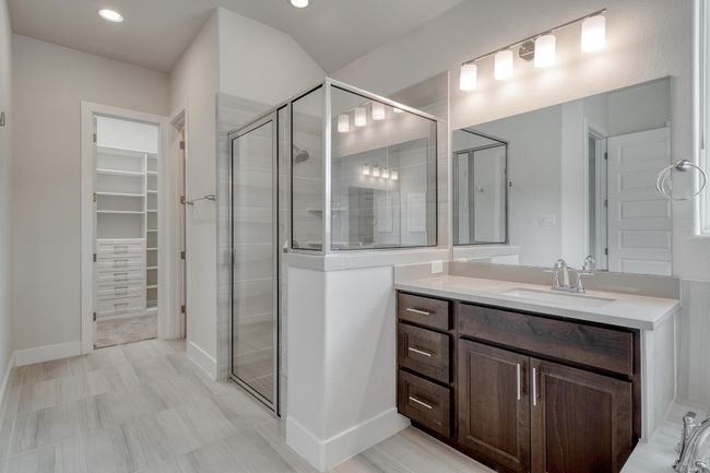 Full bath featuring vanity, a stall shower, a walk in closet, and recessed lighting | Image 19