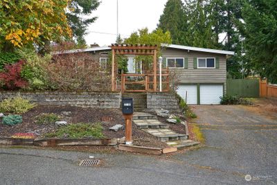 Front yard with terraced front yard and concrete walkway to mailbox. | Image 2