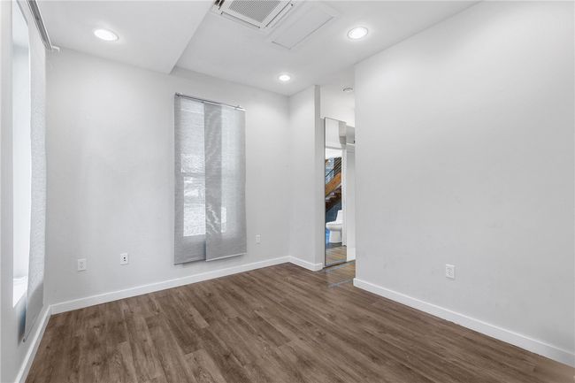 Empty room with wood finished floors and recessed lighting | Image 27
