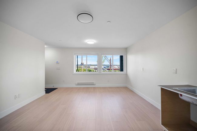 Unfurnished dining area with a baseboard heating unit and light wood finished floors | Image 24