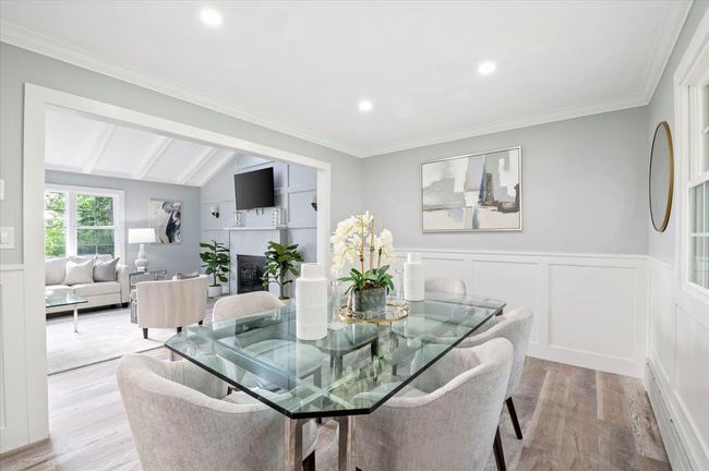 Dining room with light wood-style flooring, wainscoting, a fireplace, recessed lighting, and ornamental molding | Image 5