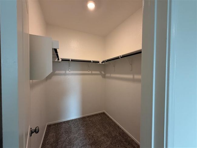 Walk in closet featuring carpet flooring | Image 7