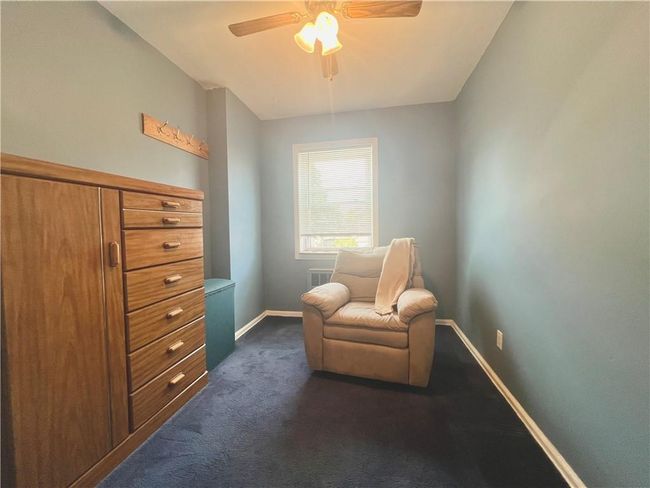 3rd bedroom with dark colored carpet and ceiling fan | Image 13